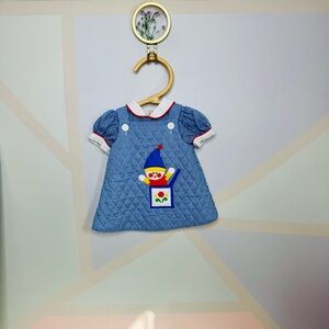 Vintage blue gingham baby dress with clown patch
